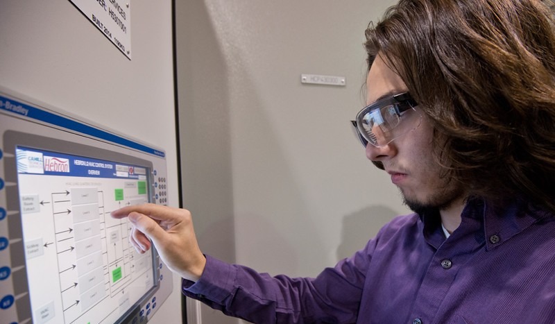Technician reviewing a control room display