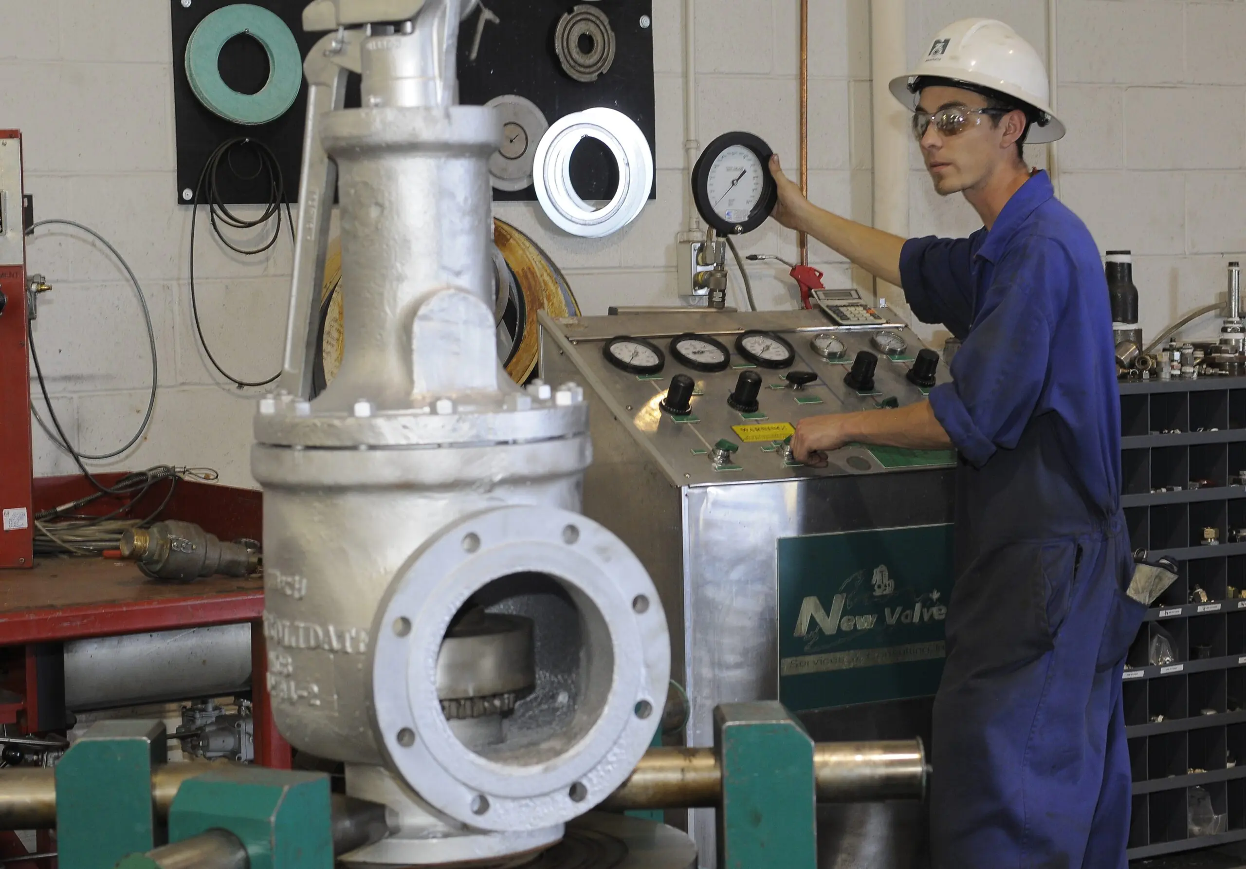 Technician servicing a valve in a workshop