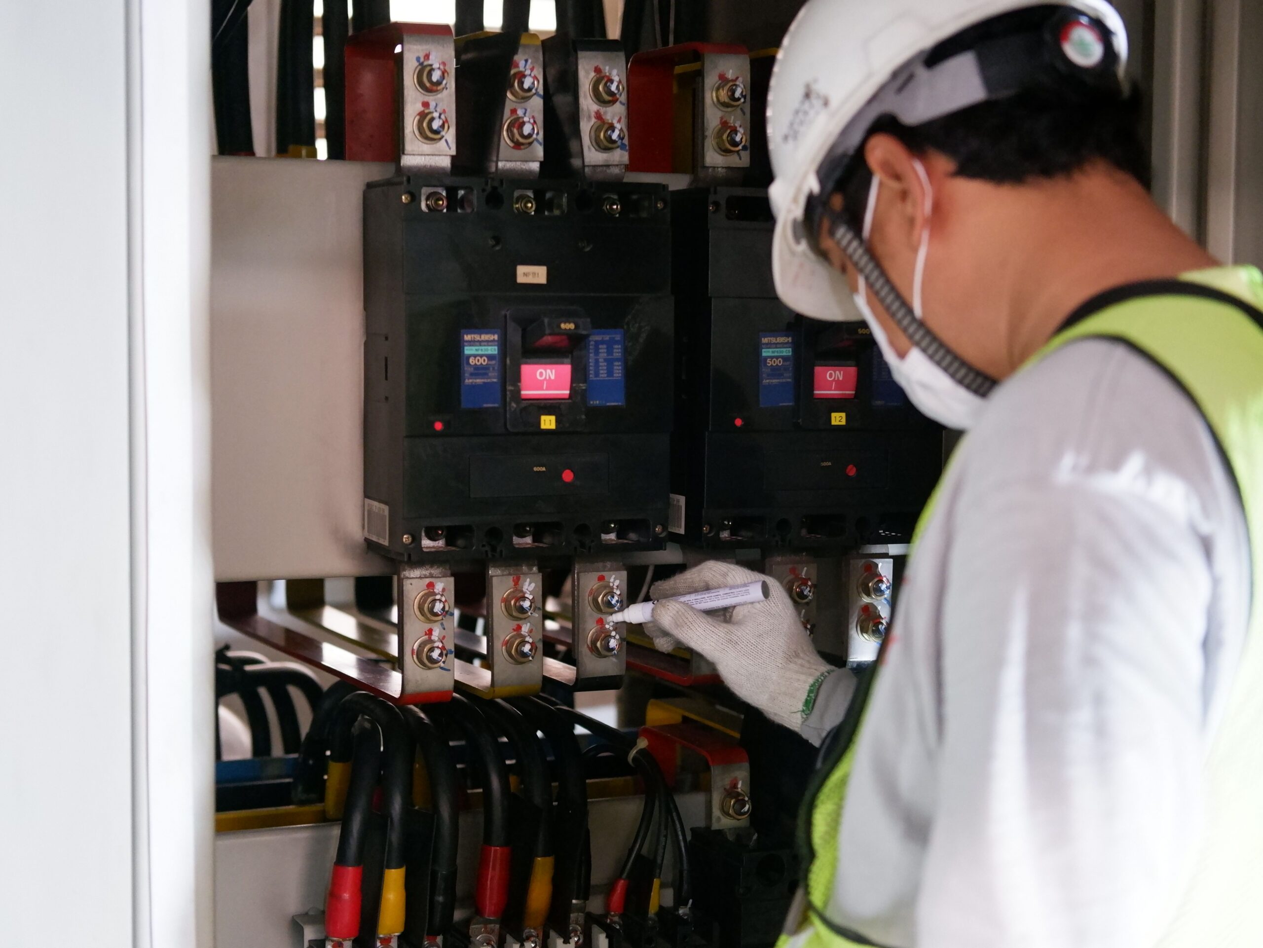 Electrician inspecting a switchgear panel