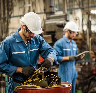 Two technicians working on electrical wiring