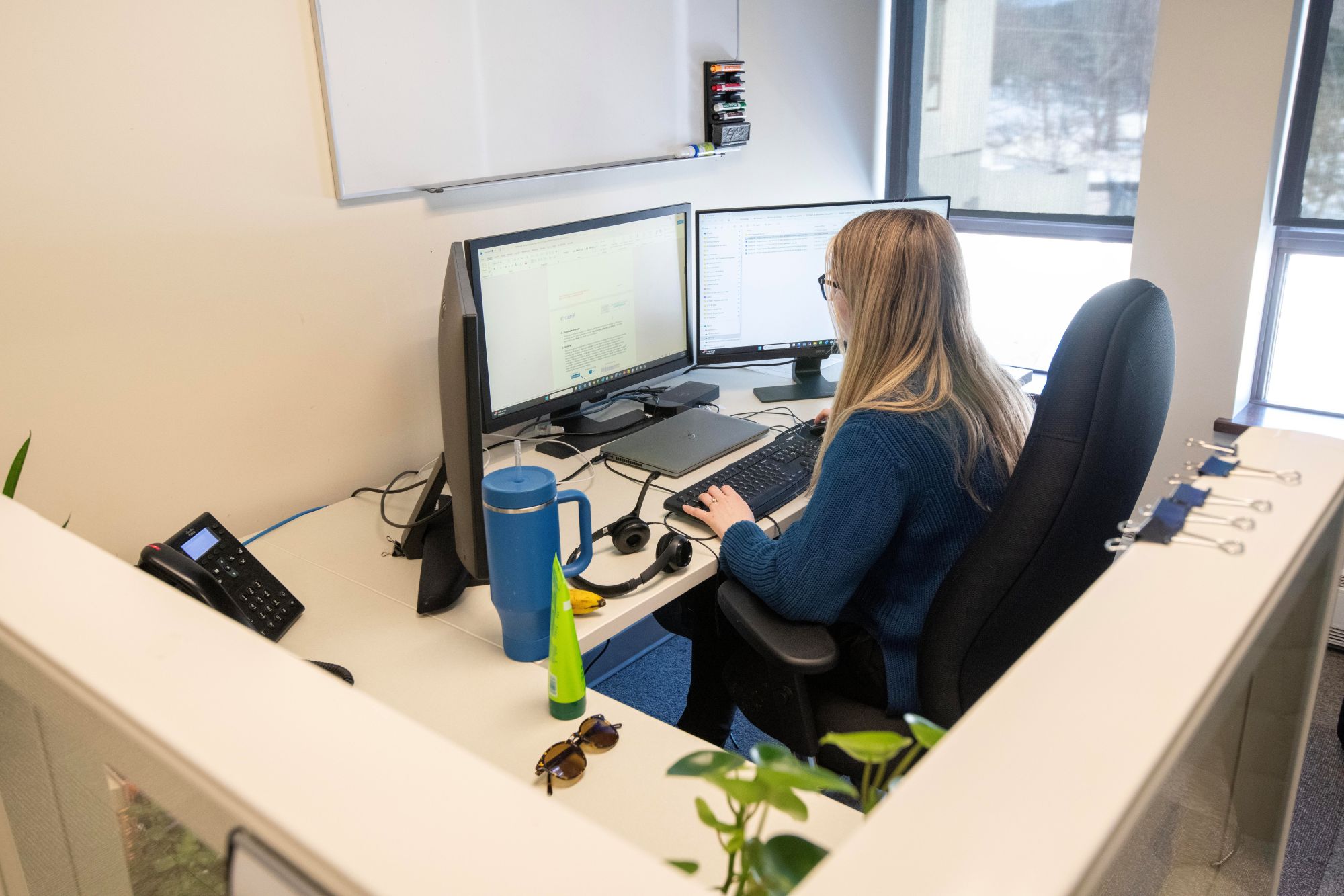 Technical staff member working at a computer in an office