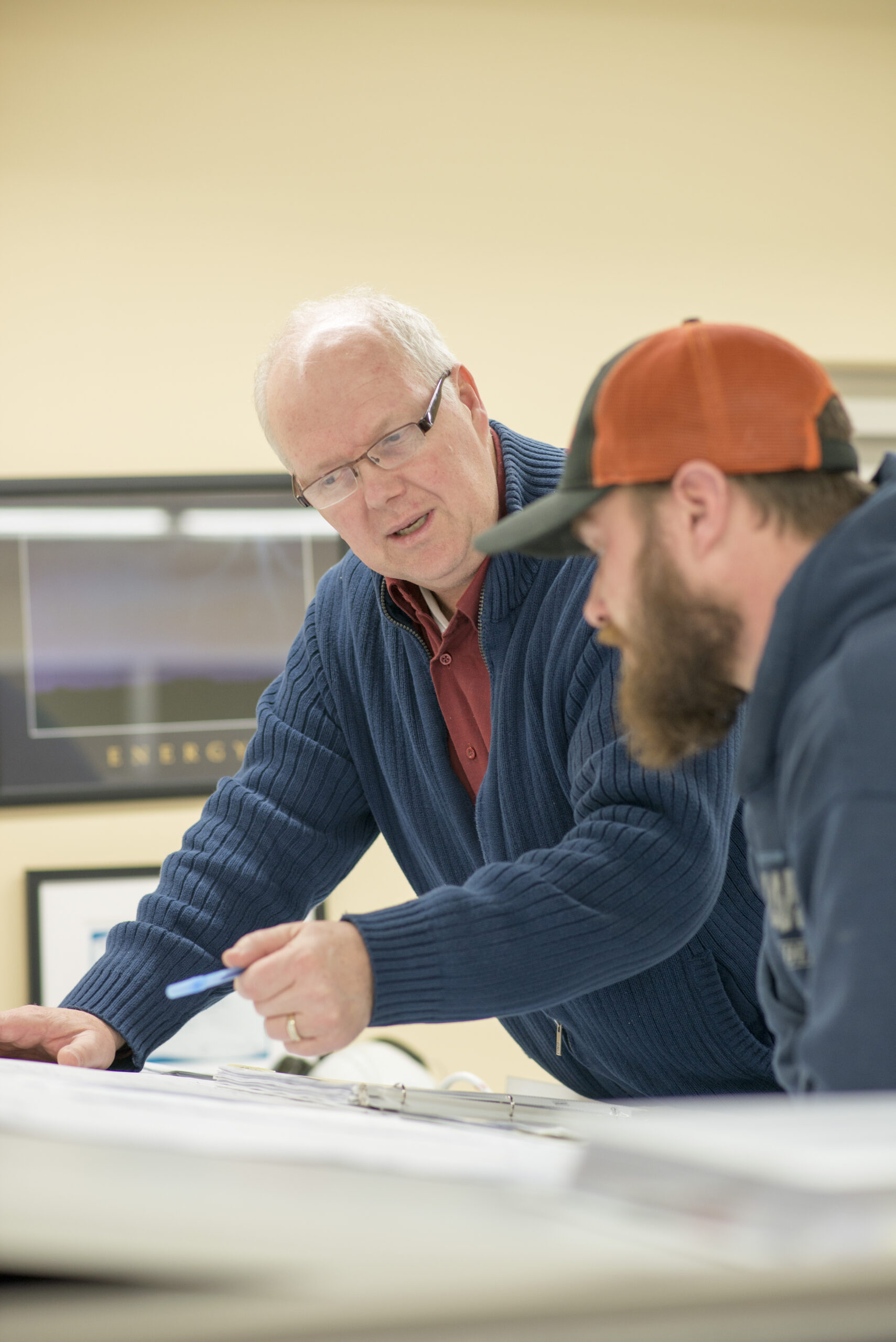 Two technical professionals reviewing project documents