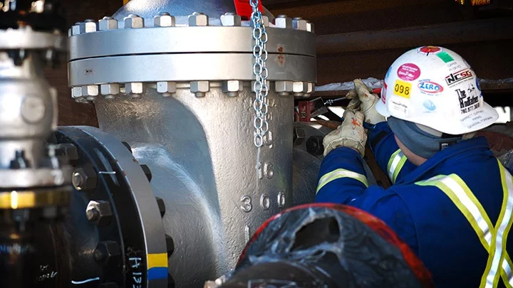 Technician working on a large industrial valve