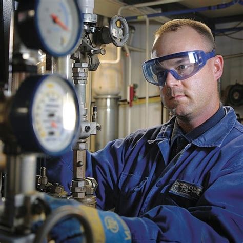 Valve technician checking pressure gauges