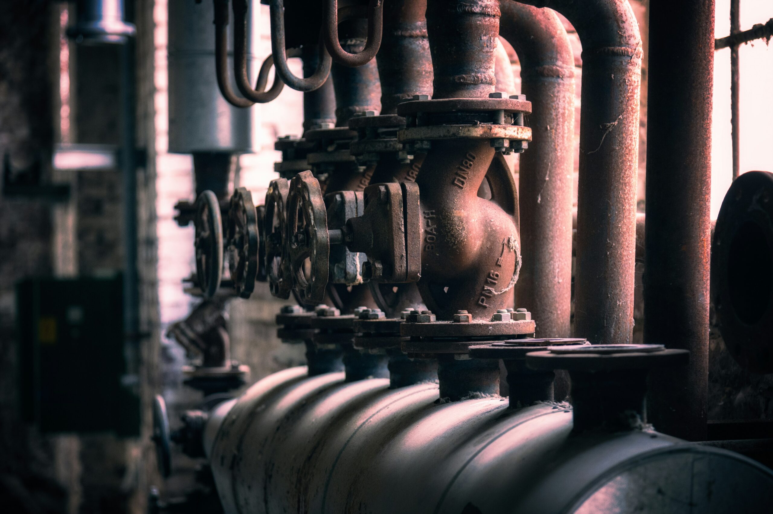 Row of industrial valves on process piping